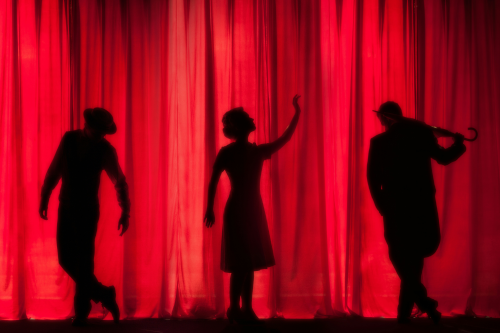 Red curtain with silhouette of 3 stage performers YouTube video thumbnails